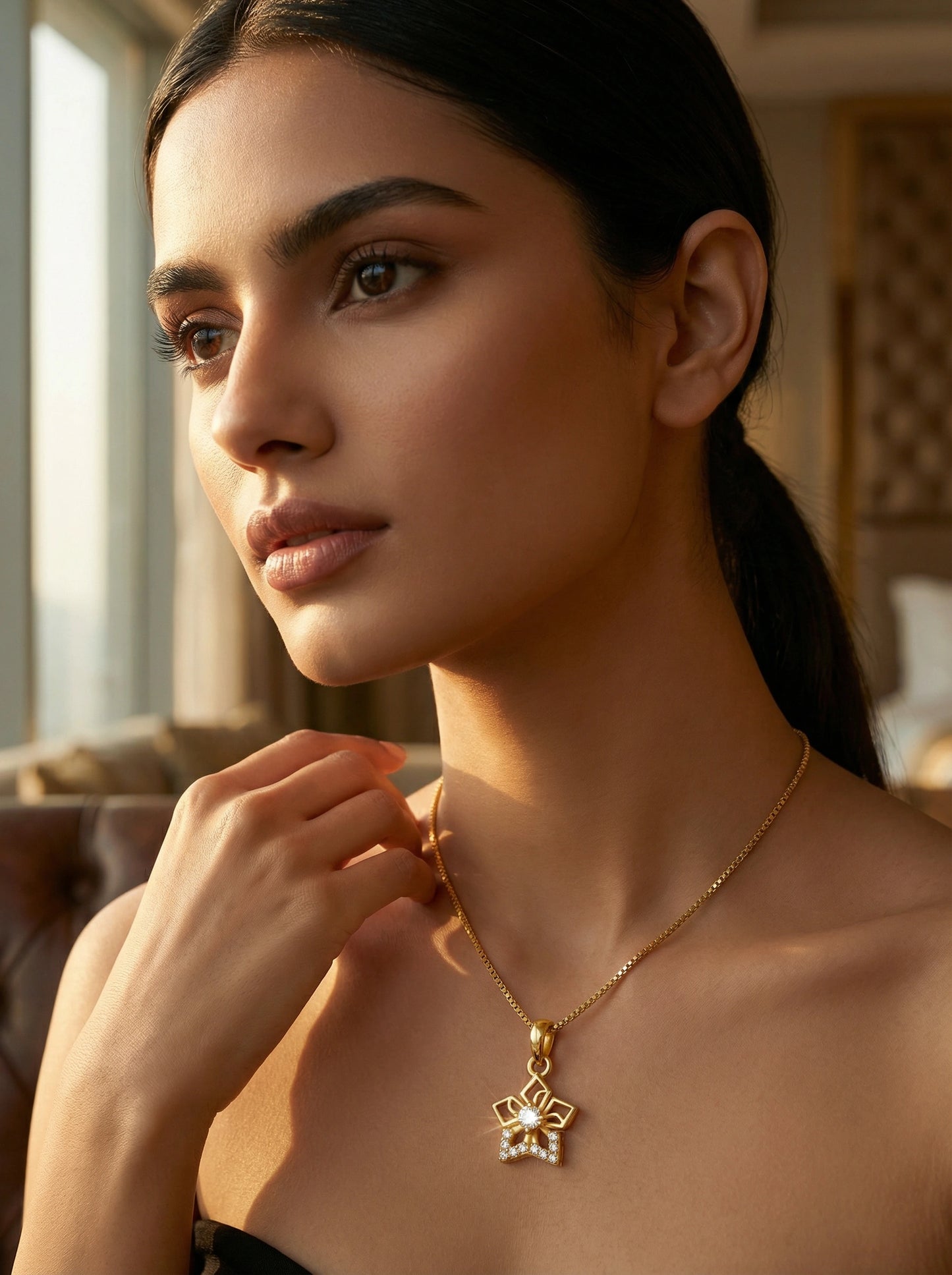woman wearing a 18k gold plated necklace with a pendant indoors