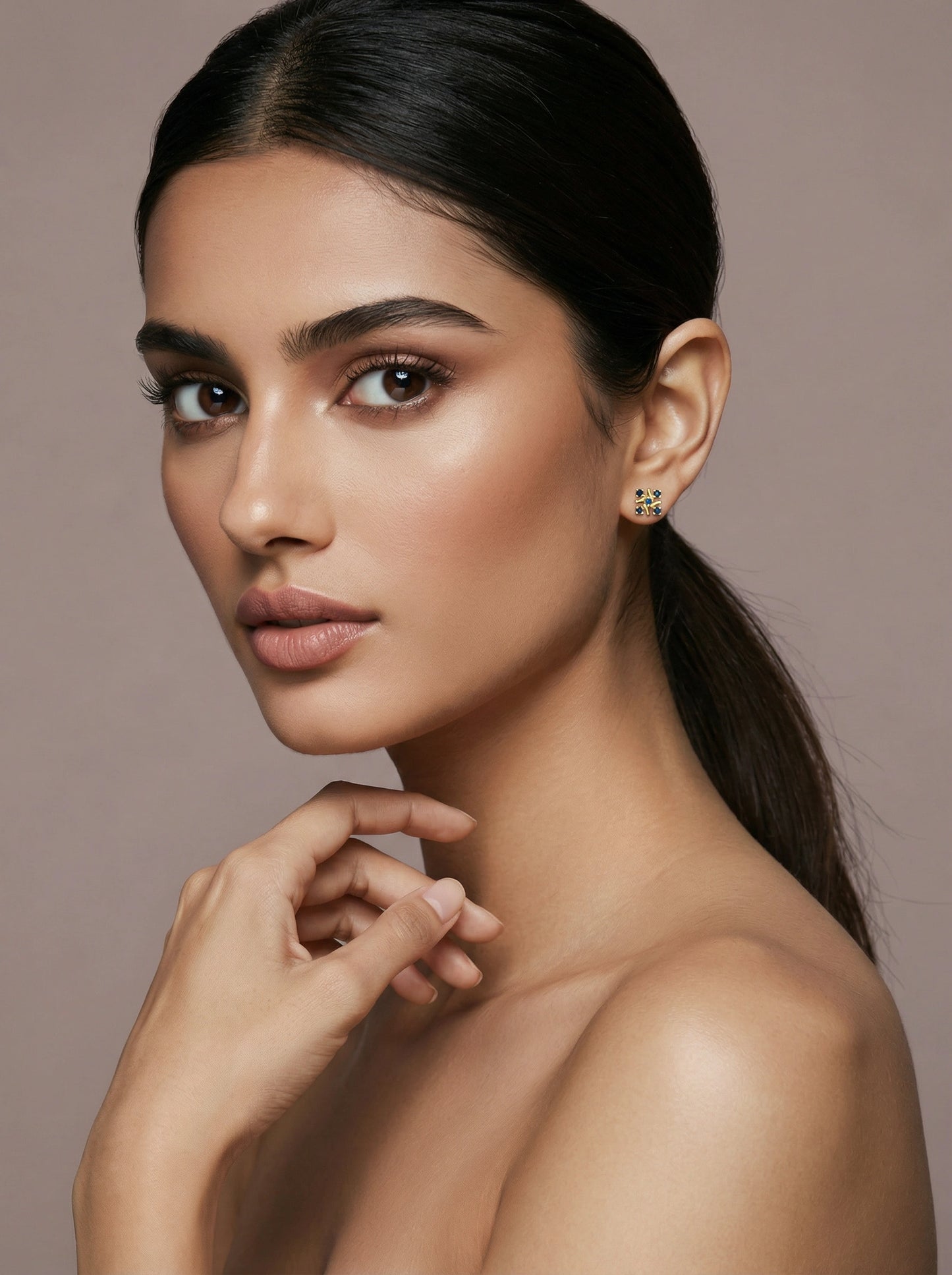 woman with a smooth neck and shoulder against a neutral background