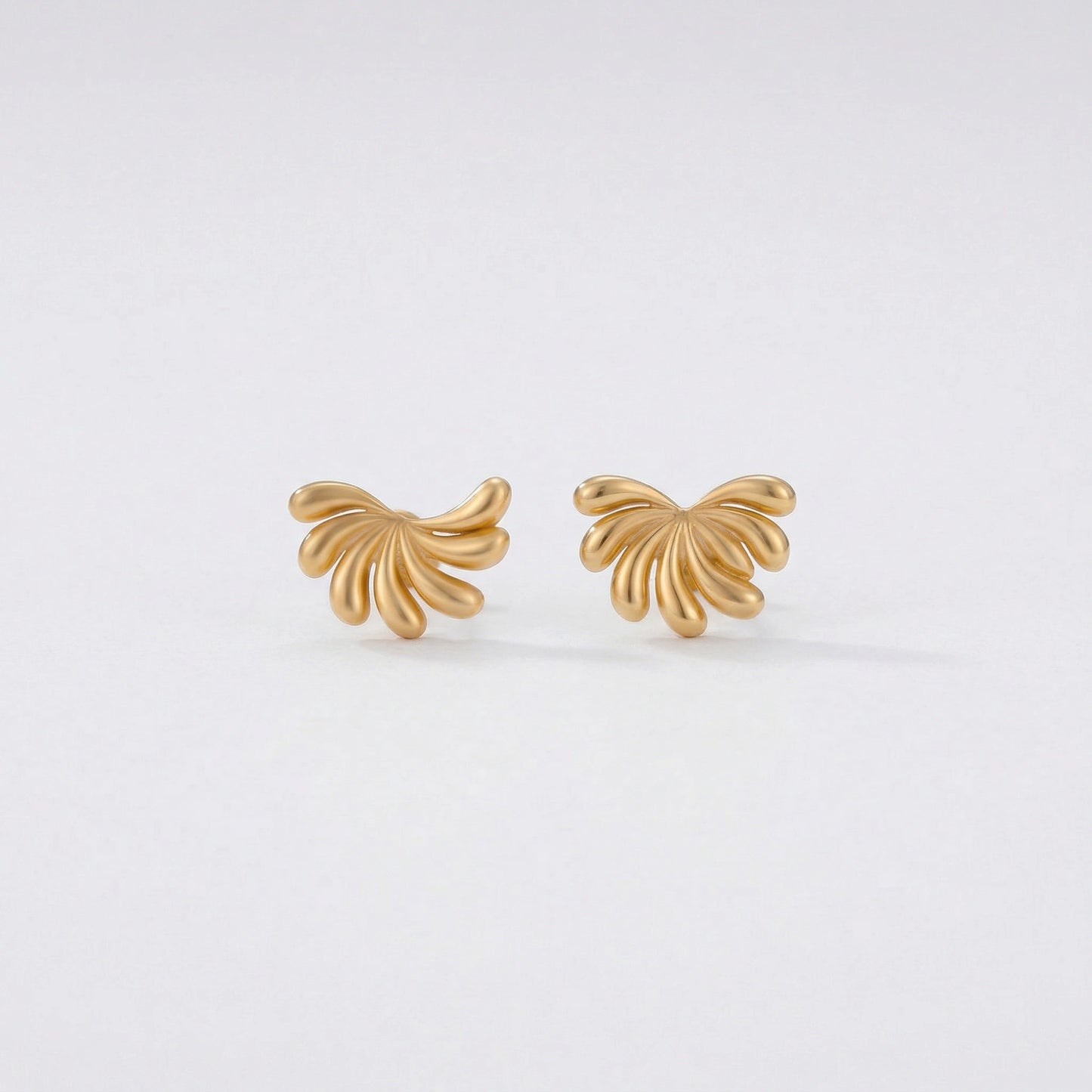 18k gold plated butterfly-shaped earrings on a light gray background