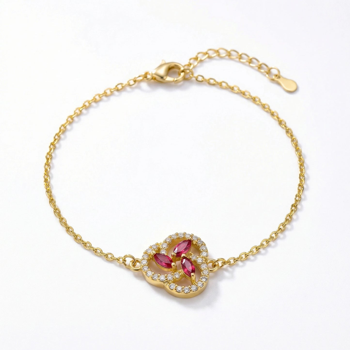 18k gold plated bracelet with a heart-shaped clasp featuring red gemstones on a white background