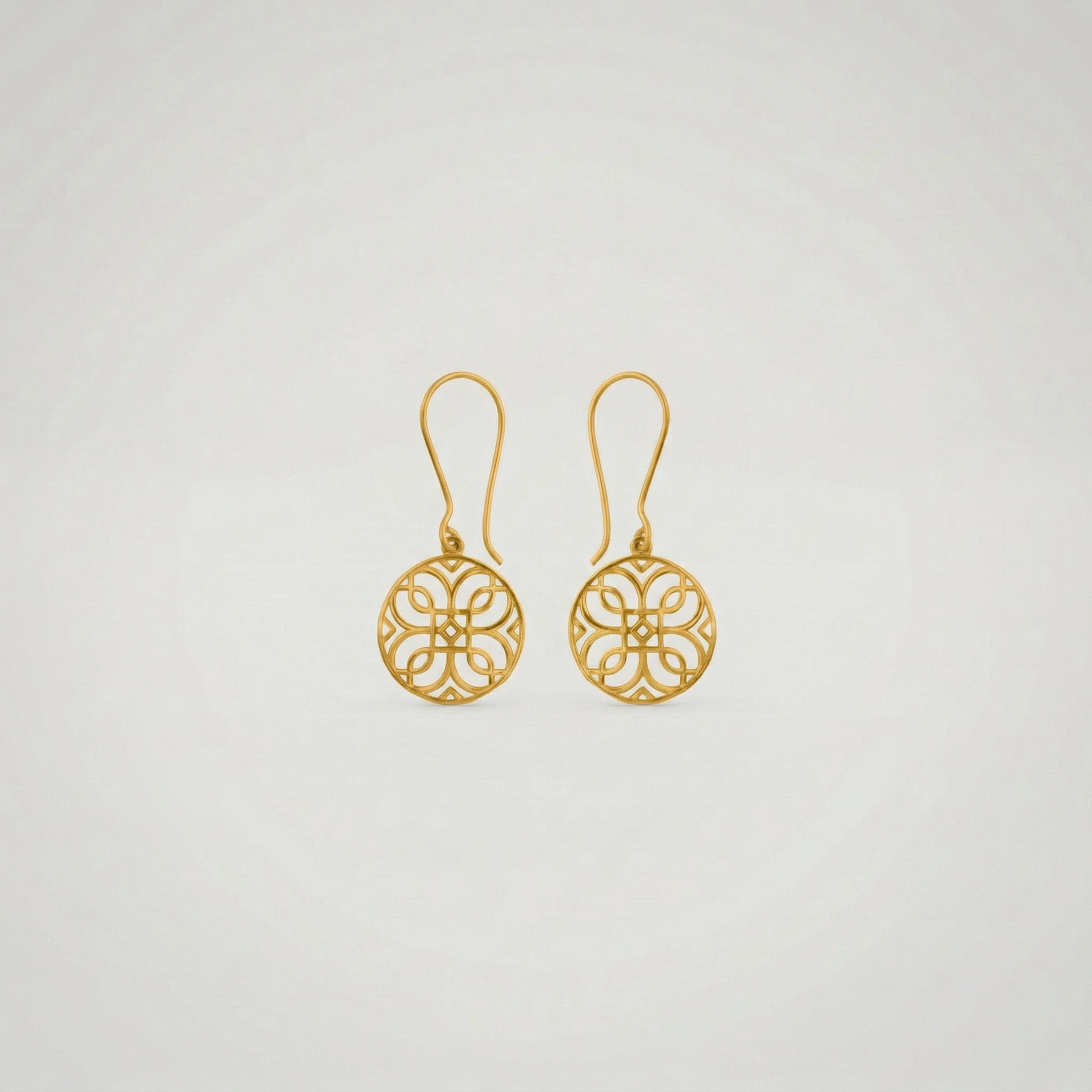 Pair of 18k gold plated earrings on a light gray background