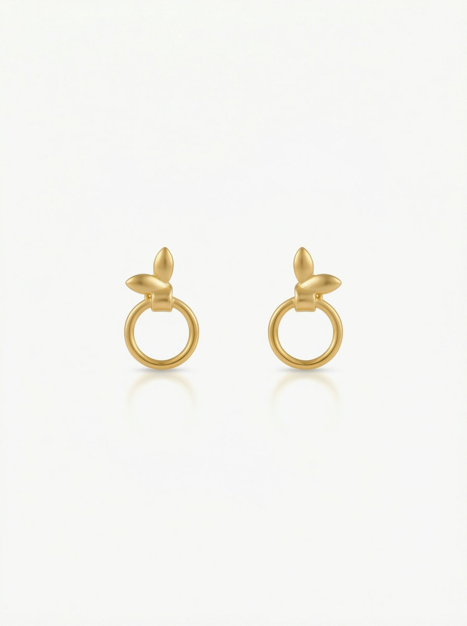 Pair of 18k gold plated earrings on a white background