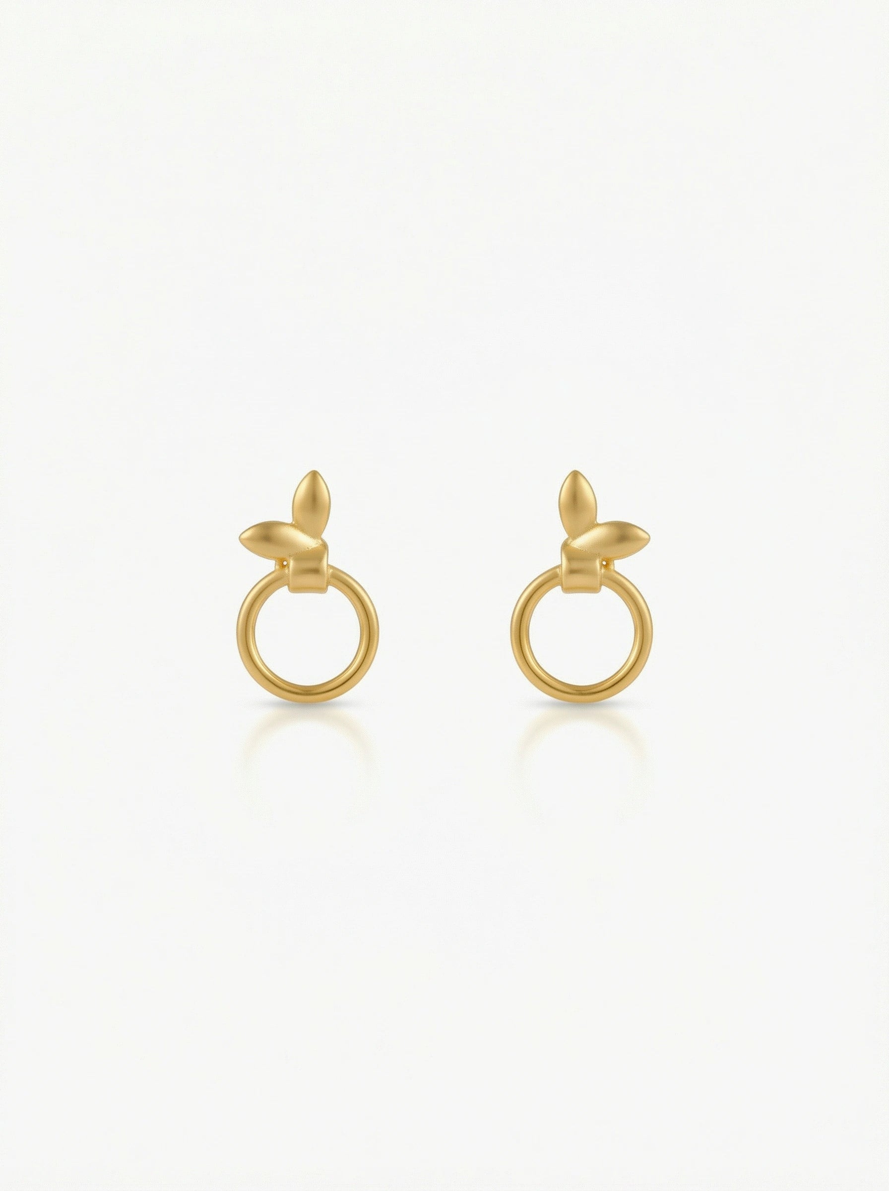 Pair of 18k gold plated earrings on a white background