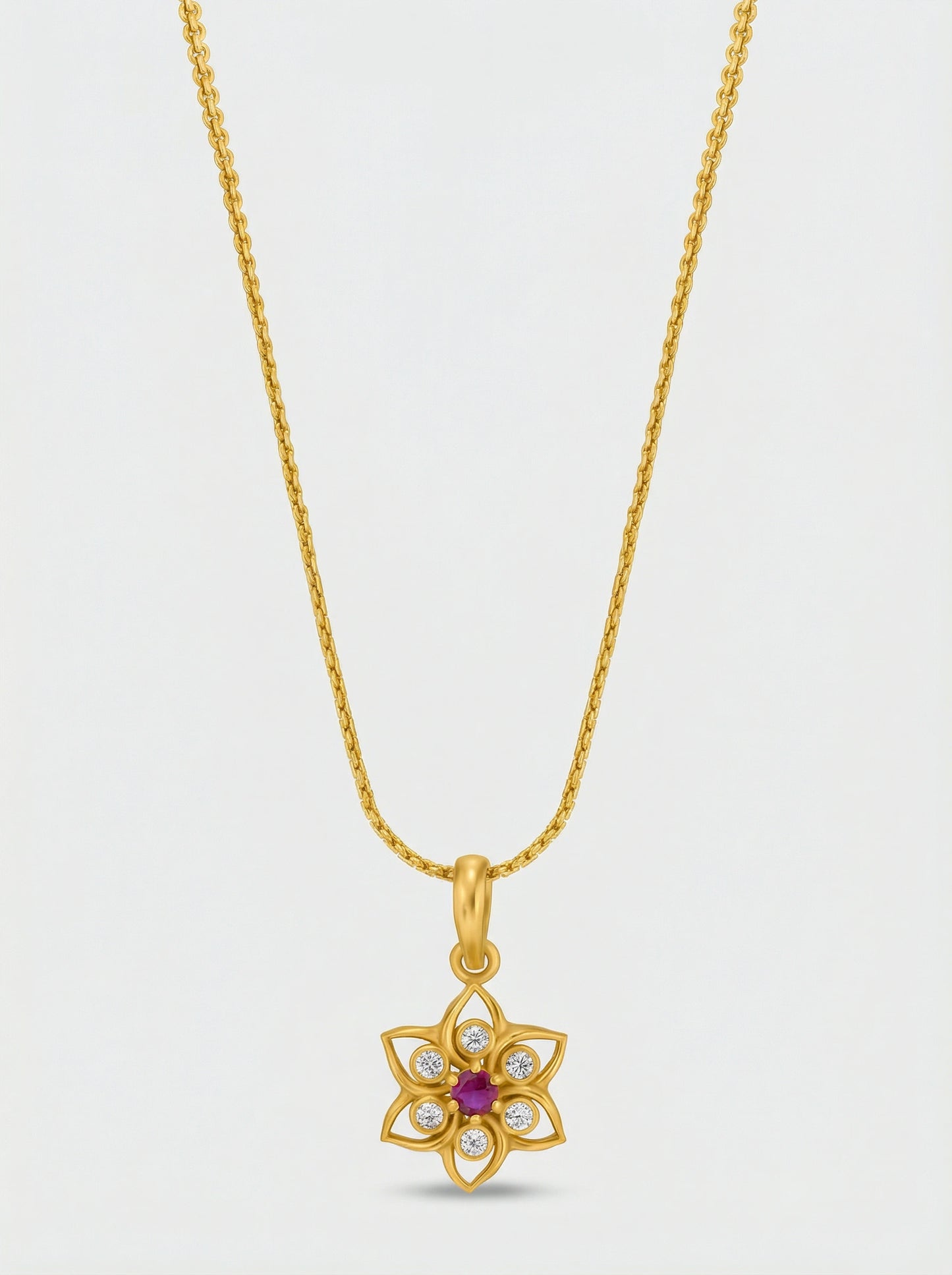 18k gold plated necklace with a floral pendant on a light gray background