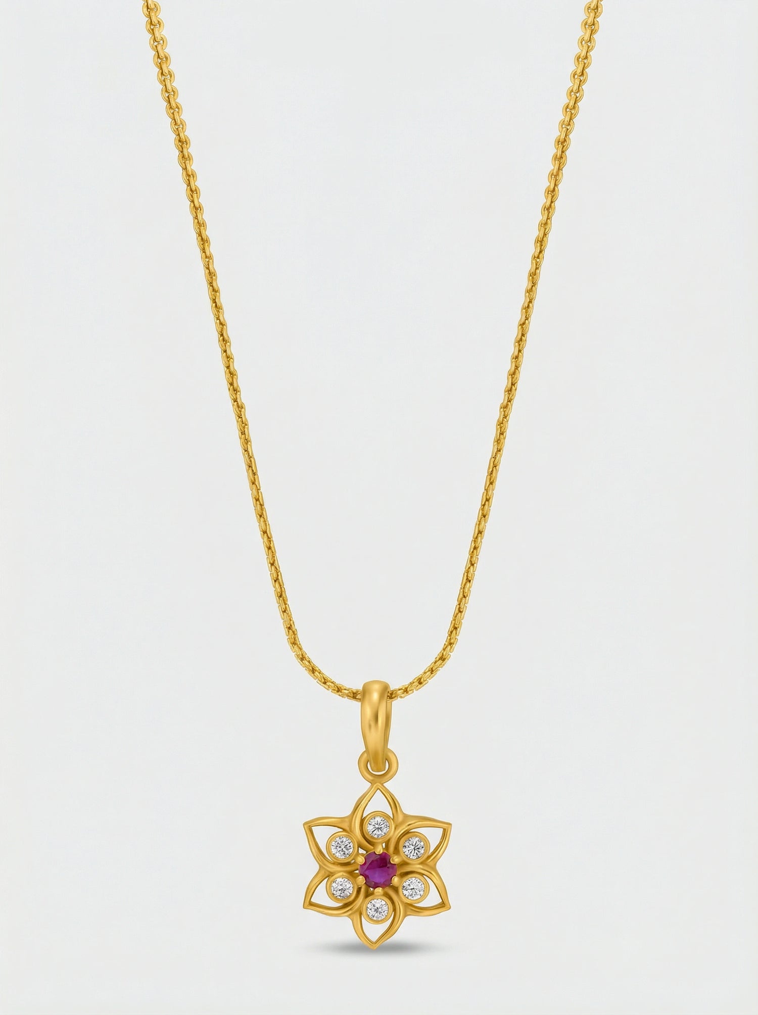 18k Gold plated necklace with a floral pendant on a light gray background