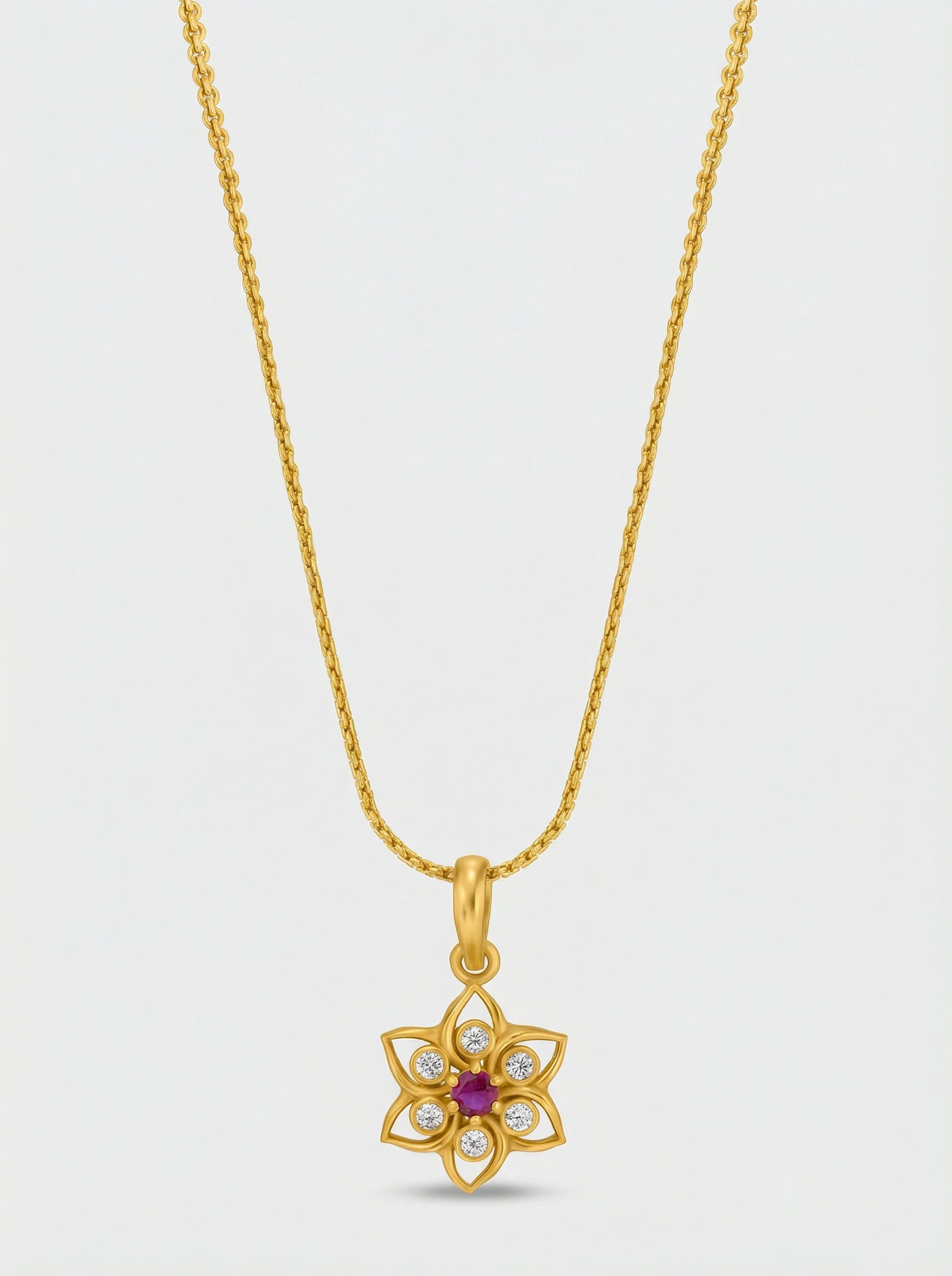 18k Gold plated necklace with a floral pendant on a light gray background