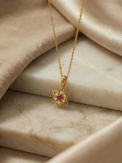 18k Gold plated necklace with a flower-shaped pendant on beige fabric