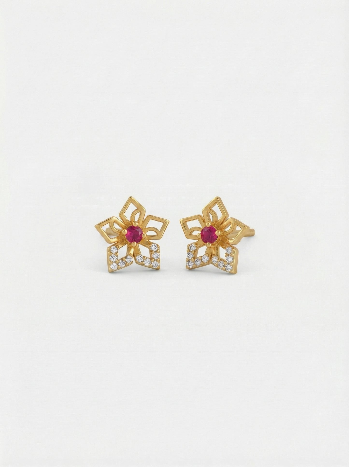 18k gold plated flower-shaped earrings with red gemstones on a white background