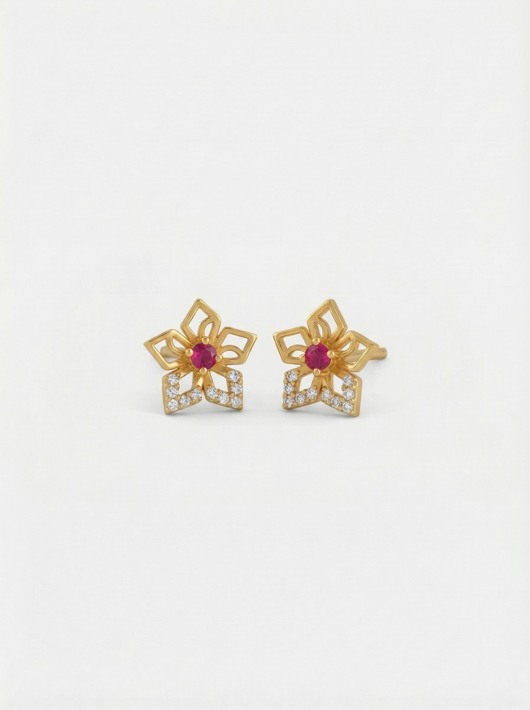 18k Gold plated flower-shaped earrings with red gemstones on a white background