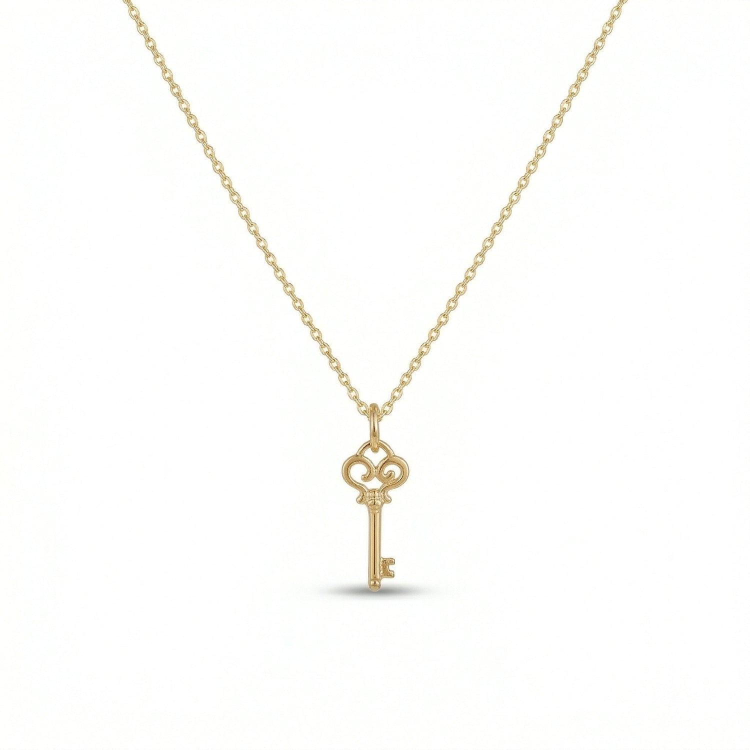 18k Gold  plated  key-shaped pendant on a chain against a white background