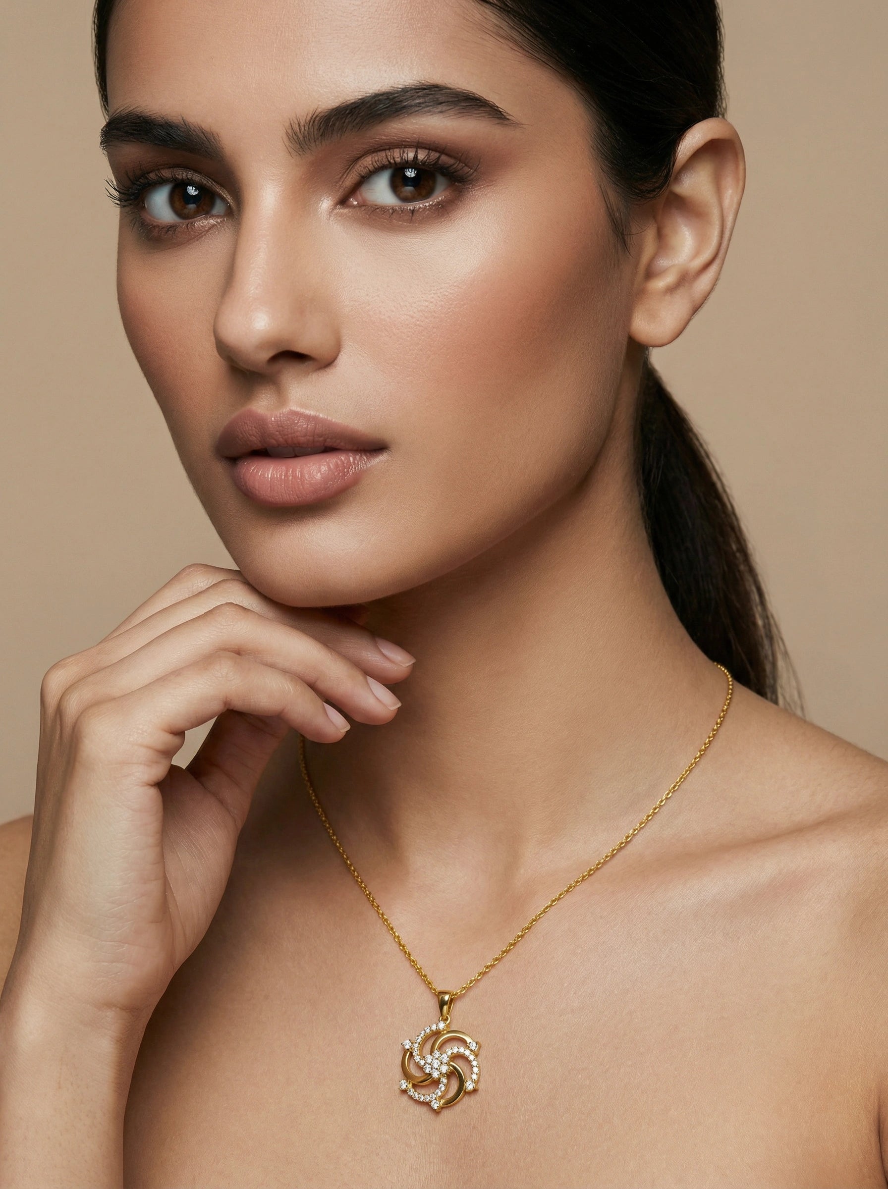 Woman wearing a 18k gold plated necklace with a heart pendant against a beige background