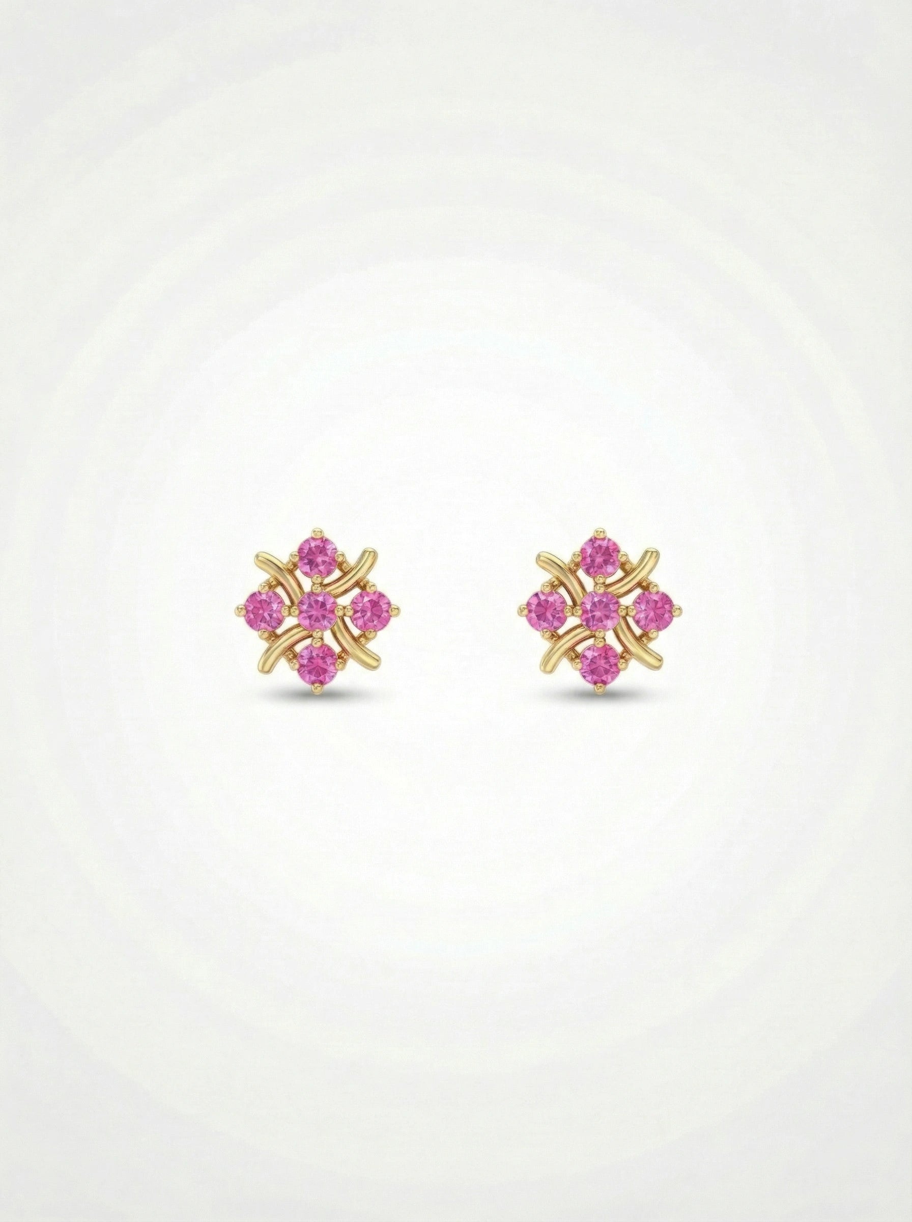 Pair of 18k gold plated earrings with pink gemstones on a white  background