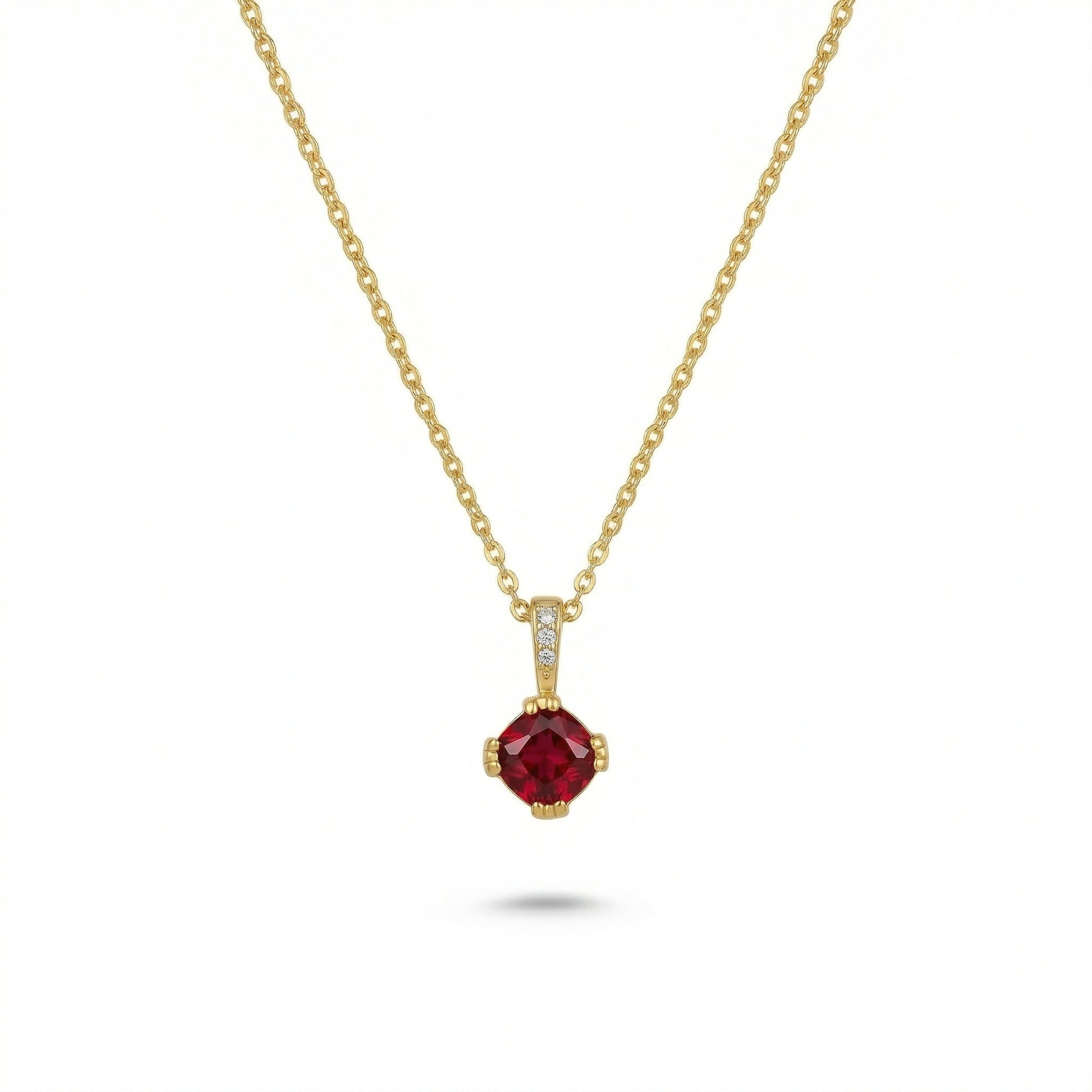 18k Gold plated necklace with a red gemstone pendant on a white background