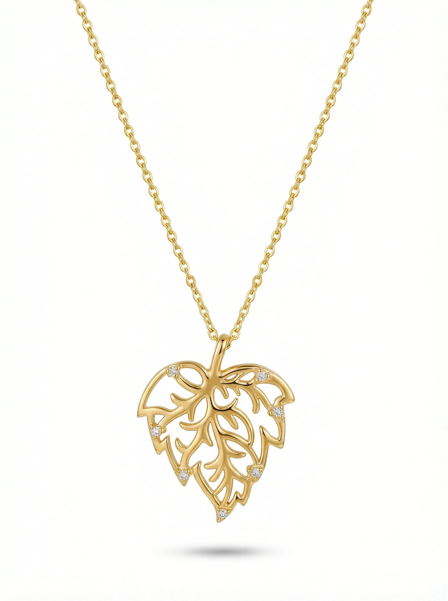 gold necklace with a leaf-shaped pendant on a white background