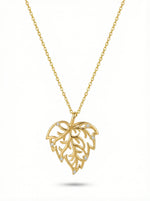 Gold necklace with a leaf-shaped pendant on a white background