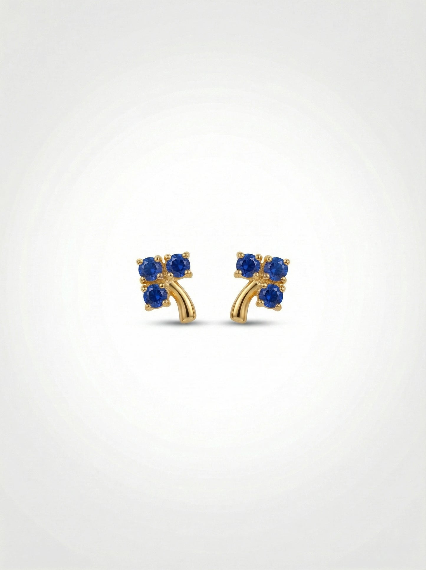 18k gold plated earrings with blue gemstones on a white background