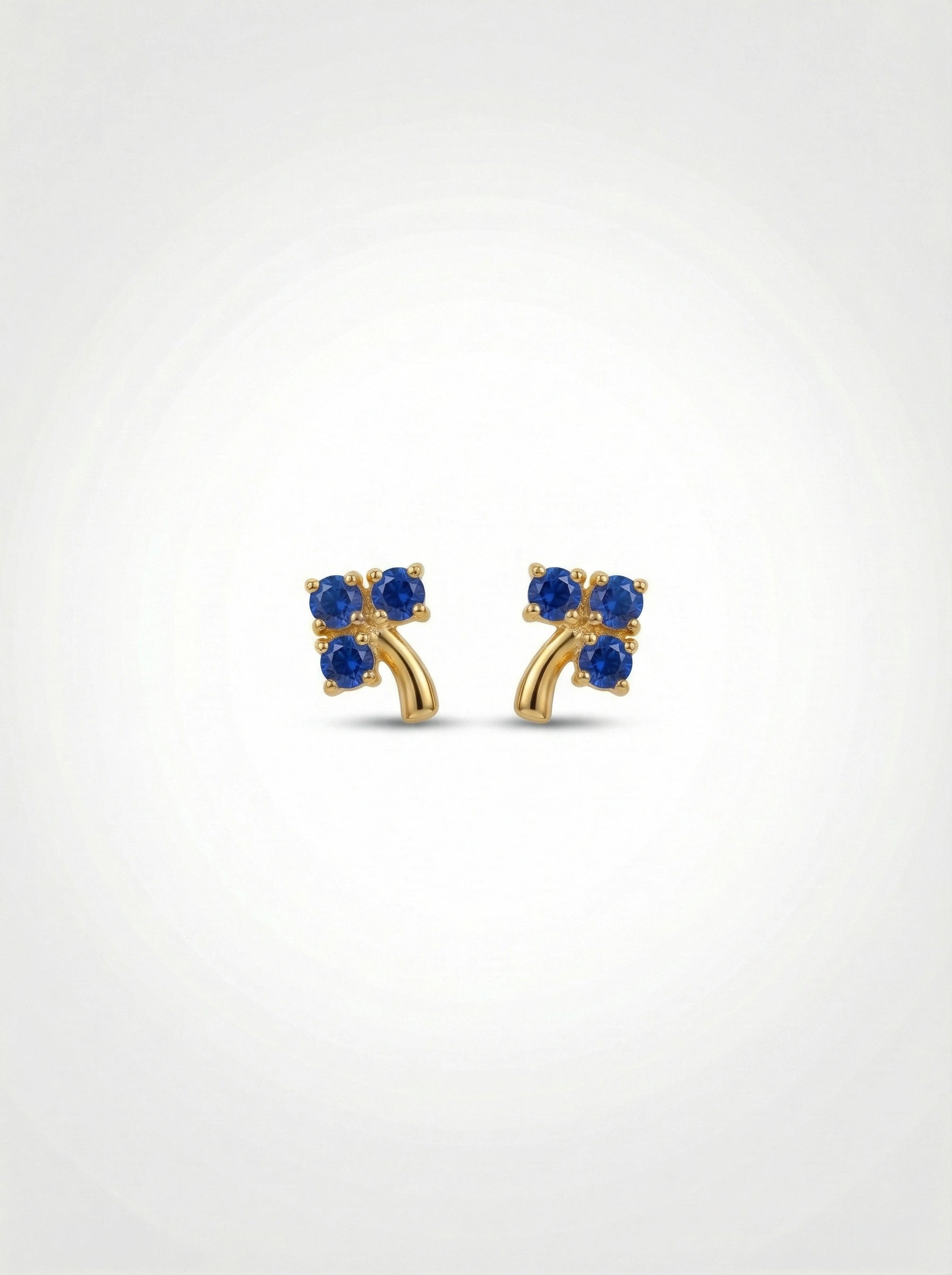 18k Gold plated earrings with blue gemstones on a white background
