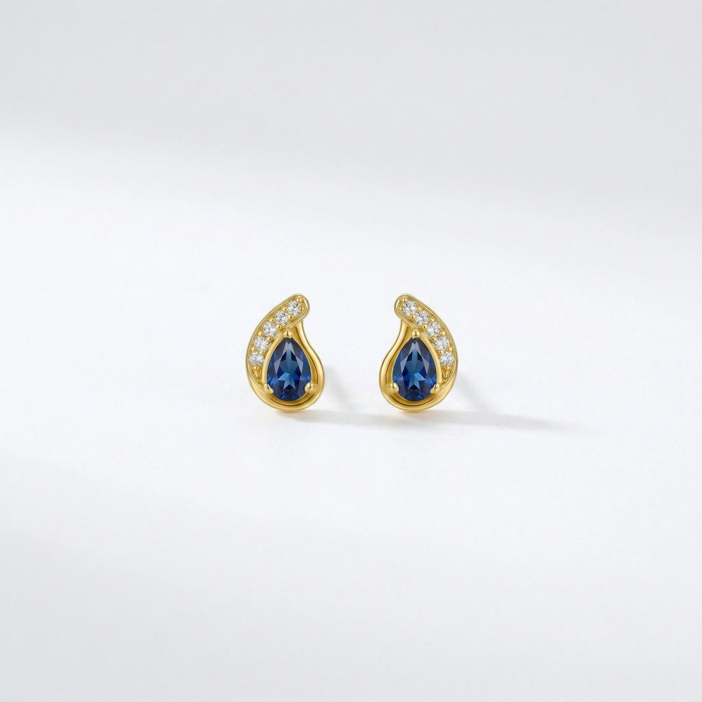 18k gold plated earrings with blue gemstones on a white background