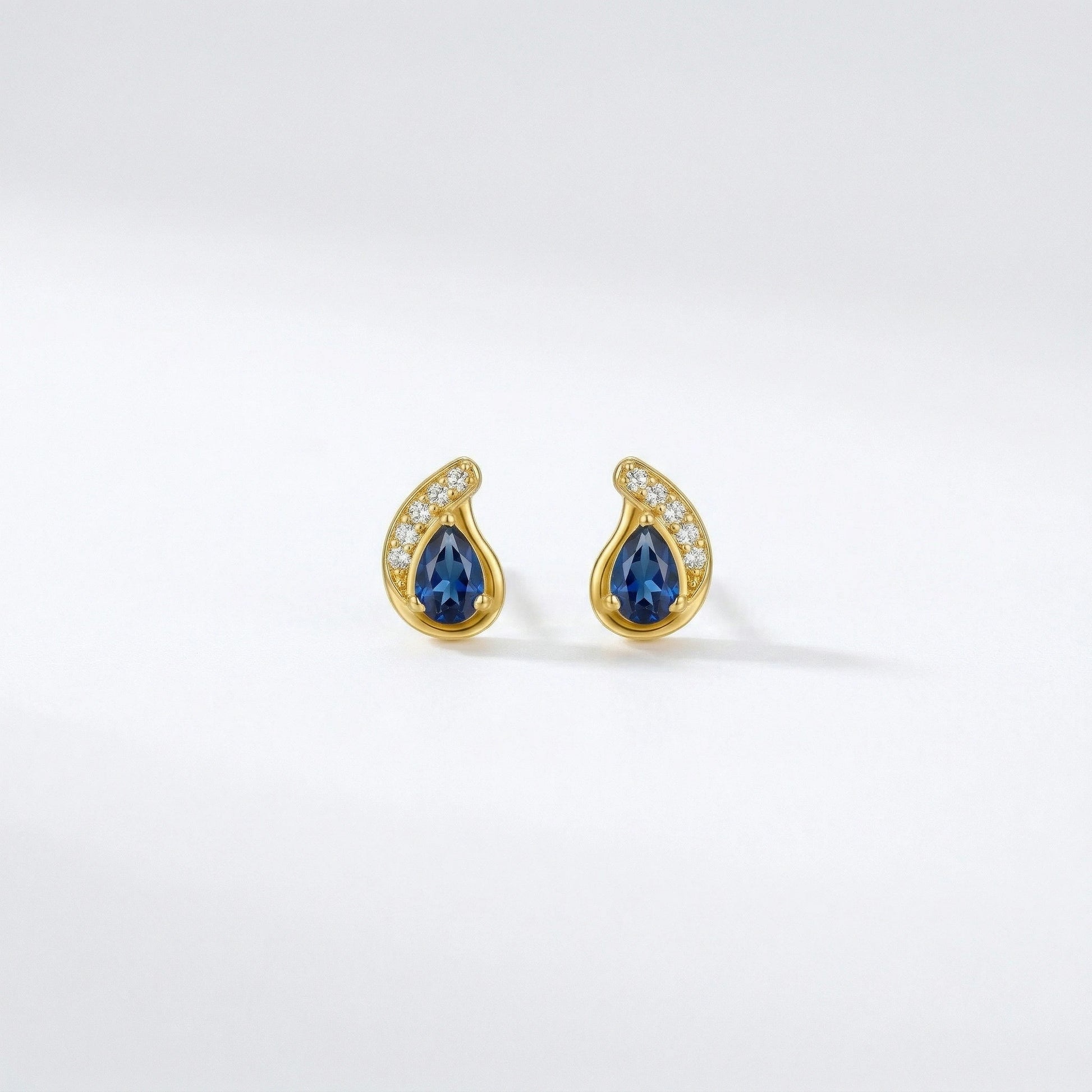 18k Gold plated earrings with blue gemstones on a white background