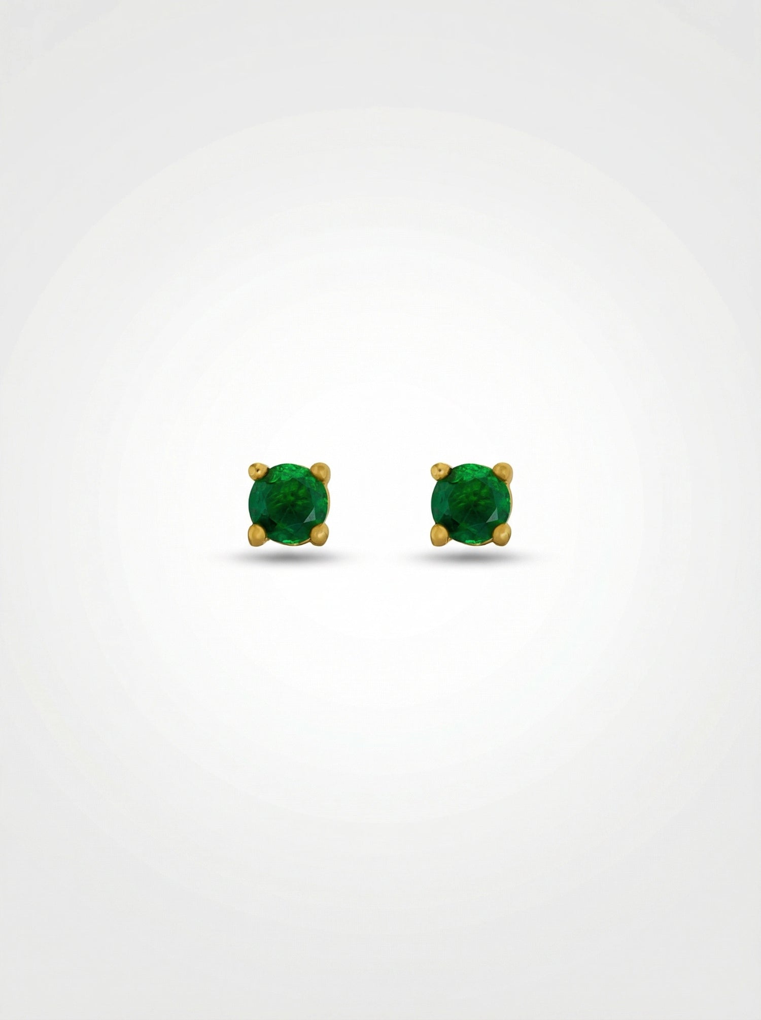 Pair of green gemstone earrings with 18k gold plated settings on a white background