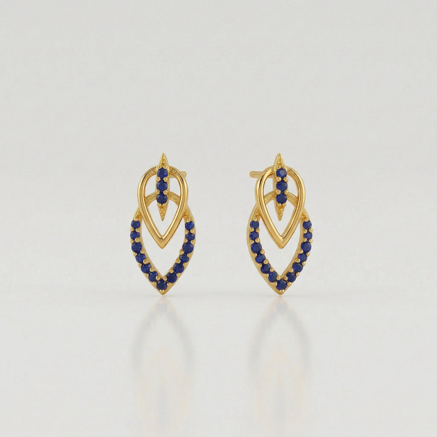 18k gold plated  earrings with blue stones on a light gray background