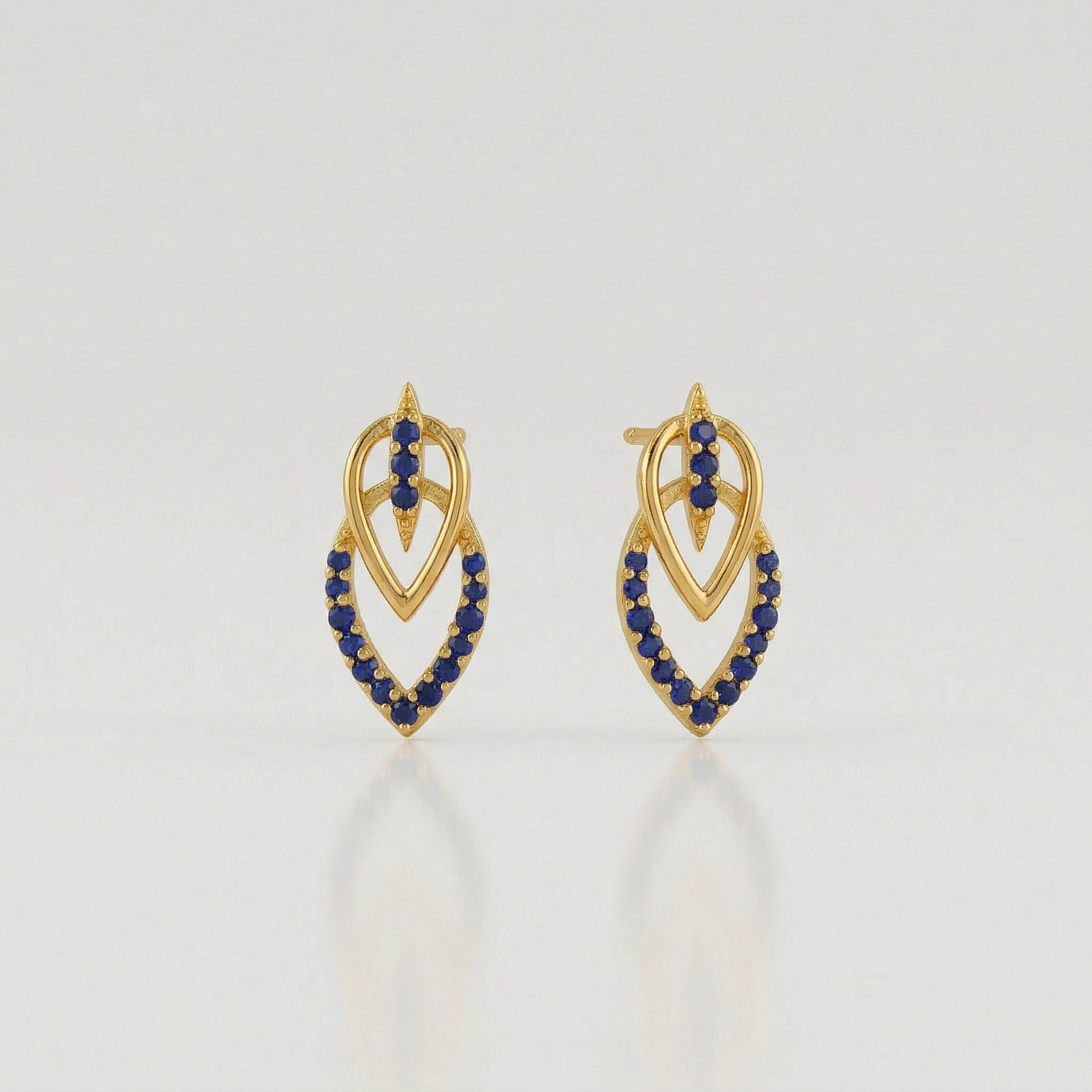 18k Gold plated  earrings with blue stones on a light gray background