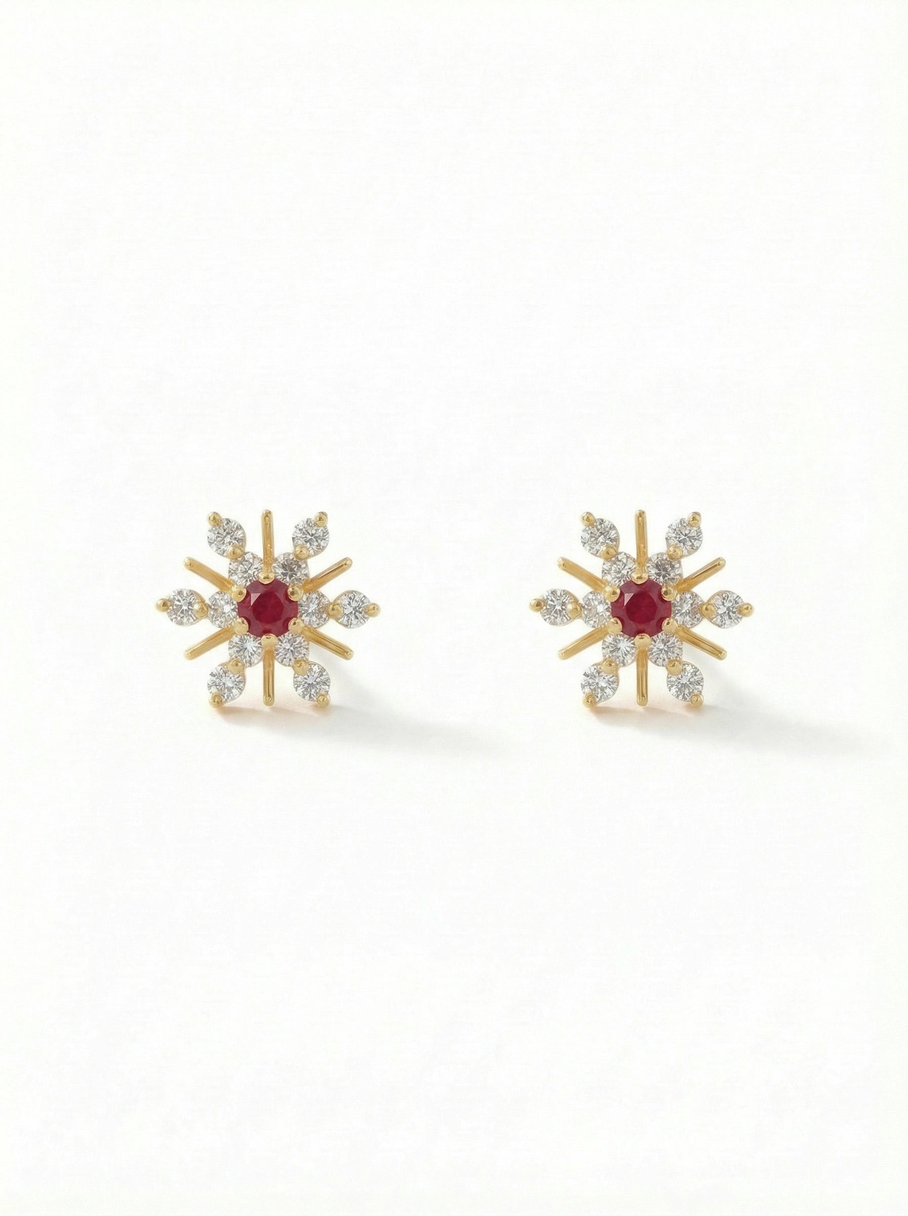 Pair of silver heart-shaped 18k gold plated earrings on a white background