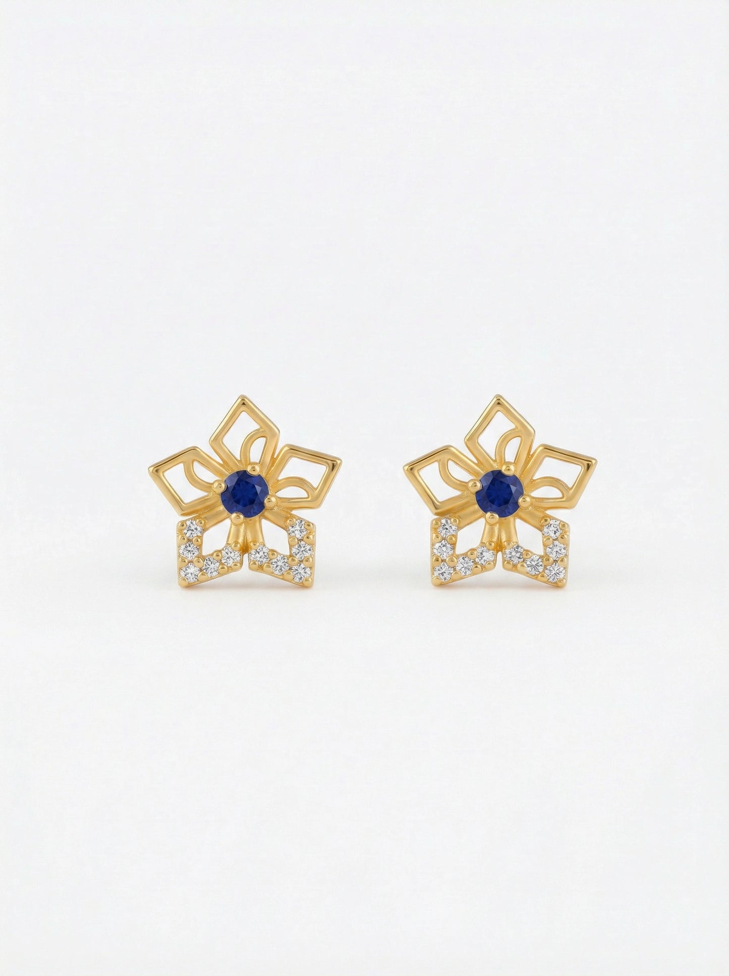 pair of 18k gold plated earrings with blue gemstones on a white background