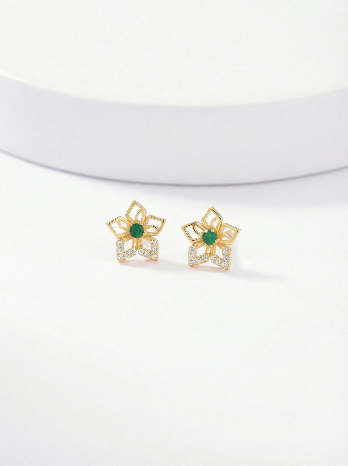 pair of 18k gold plated earrings with green gemstones on a white background 