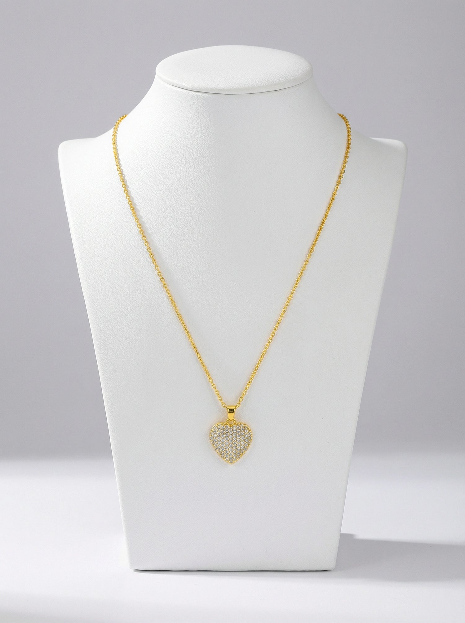 18k Gold plated necklace with a heart-shaped pendant on a white mannequin bust against a gray background