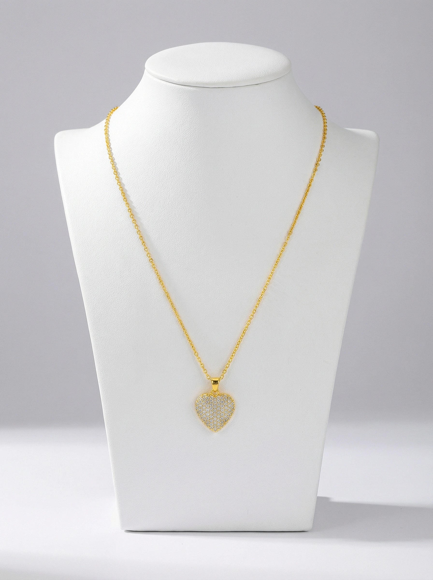 18k Gold plated necklace with a heart-shaped pendant on a white mannequin bust against a gray background