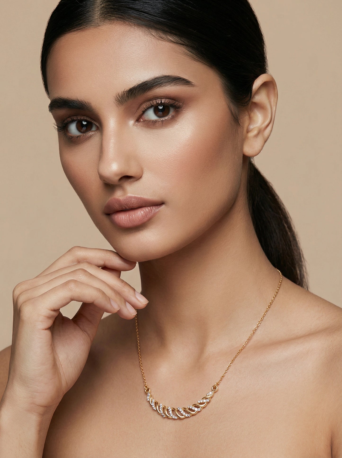 woman wearing a 18k  gold plated necklace against a beige background