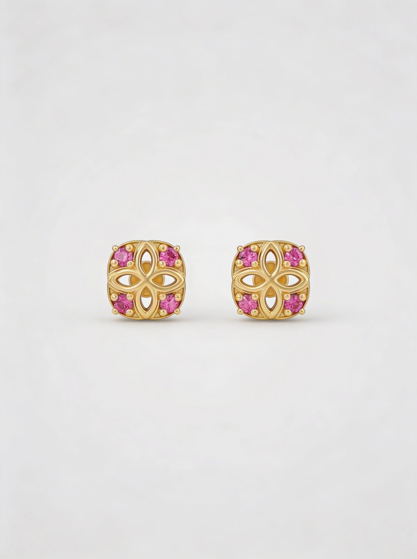 18k gold plated earrings with pink gemstones on a white background
