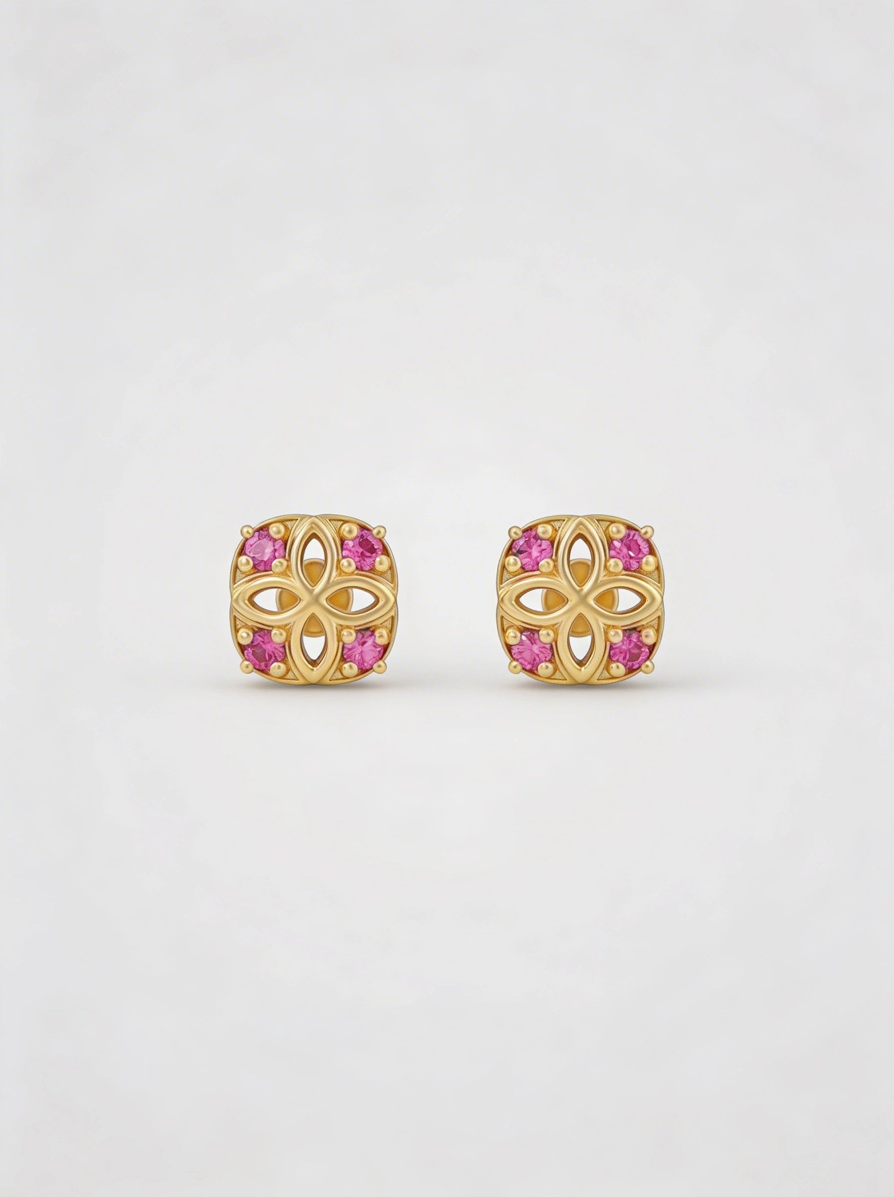 18k Gold plated earrings with pink gemstones on a white background