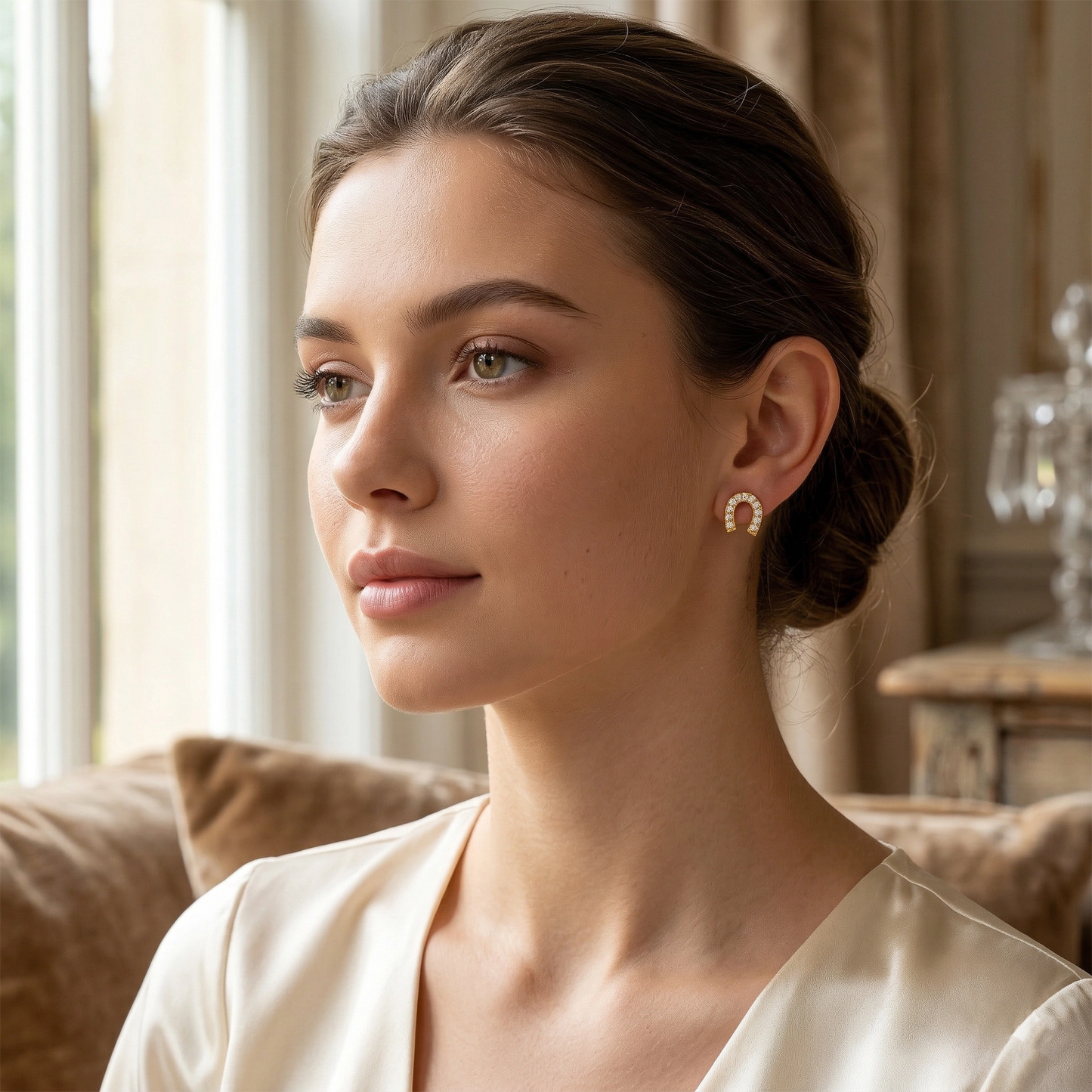 woman wearing earrings in a cozy indoor setting 18k plated