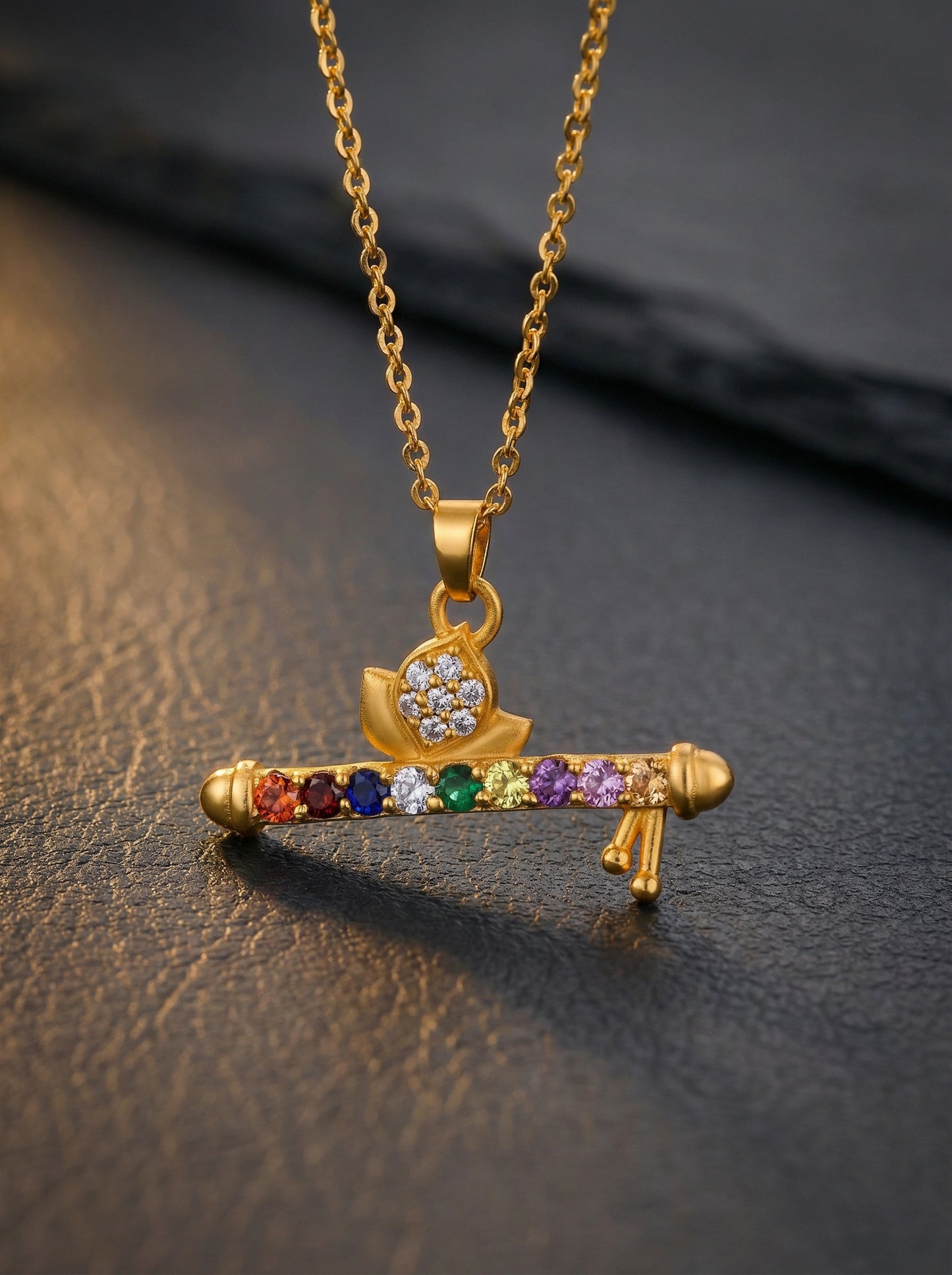 18k gold plated necklace with a colorful pendant on a dark surface