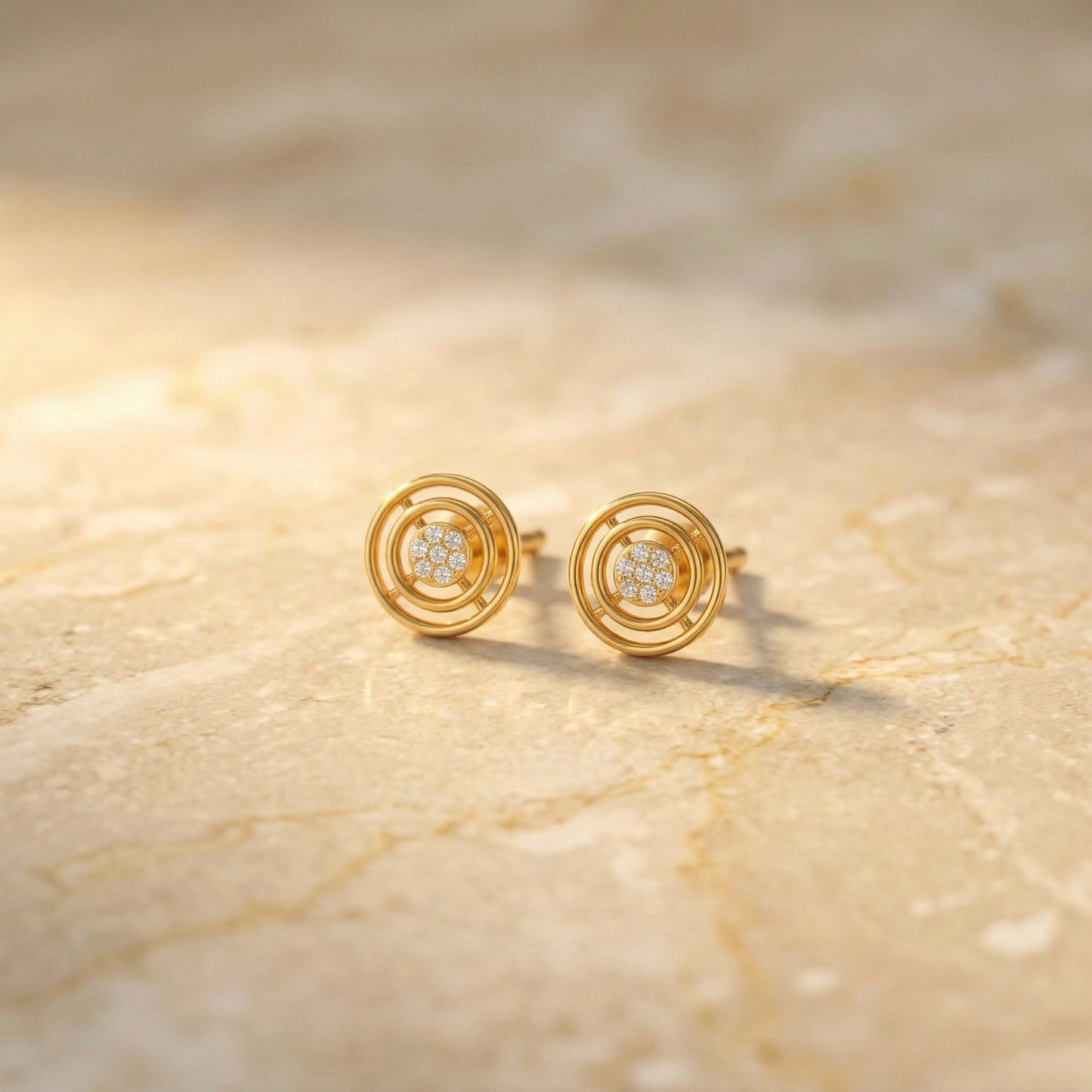 18k gold plated earrings with diamond accents on a beige marble surface