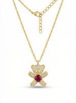 18k Gold plated necklace with a teddy bear pendant featuring a red gemstone on a white background
