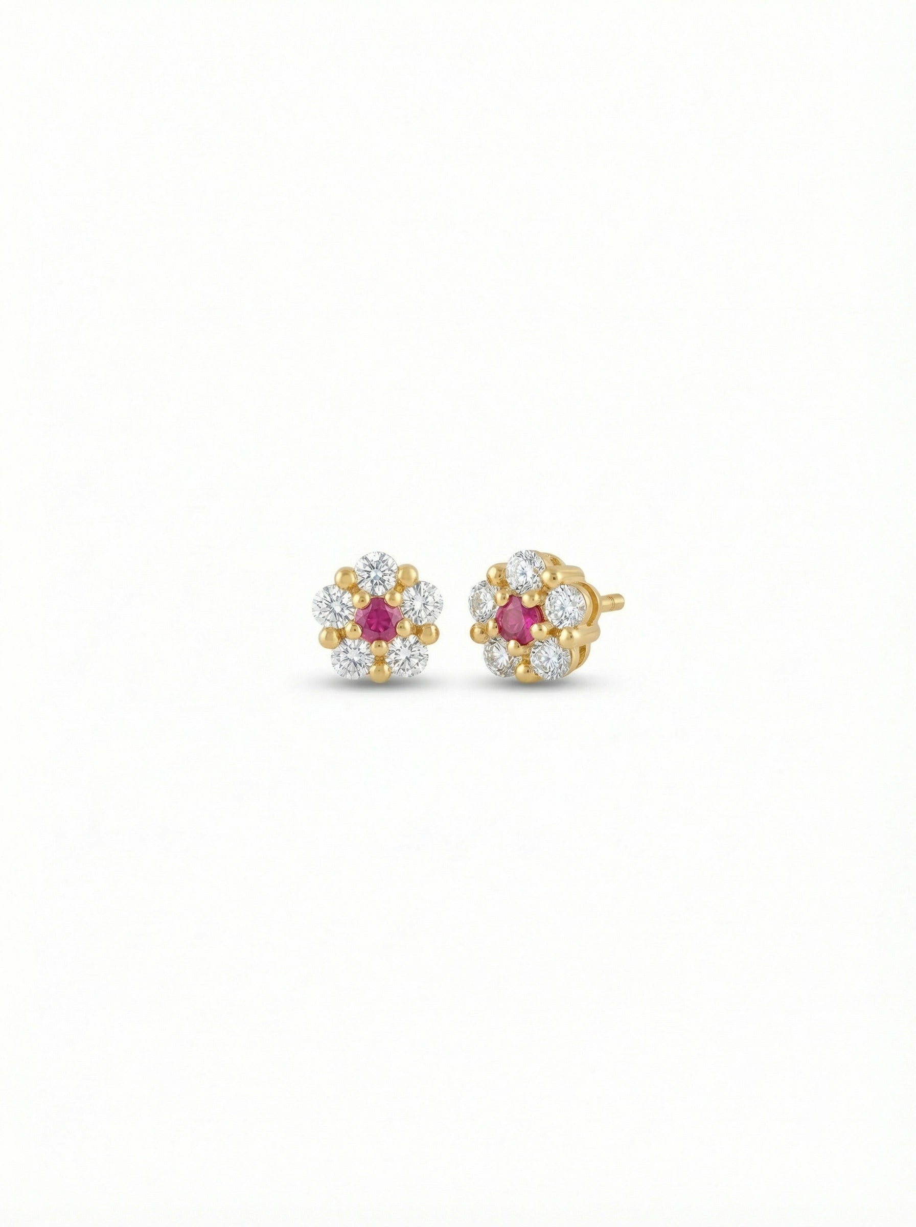 Pair of 18k gold plated earrings with ruby stones on a white background