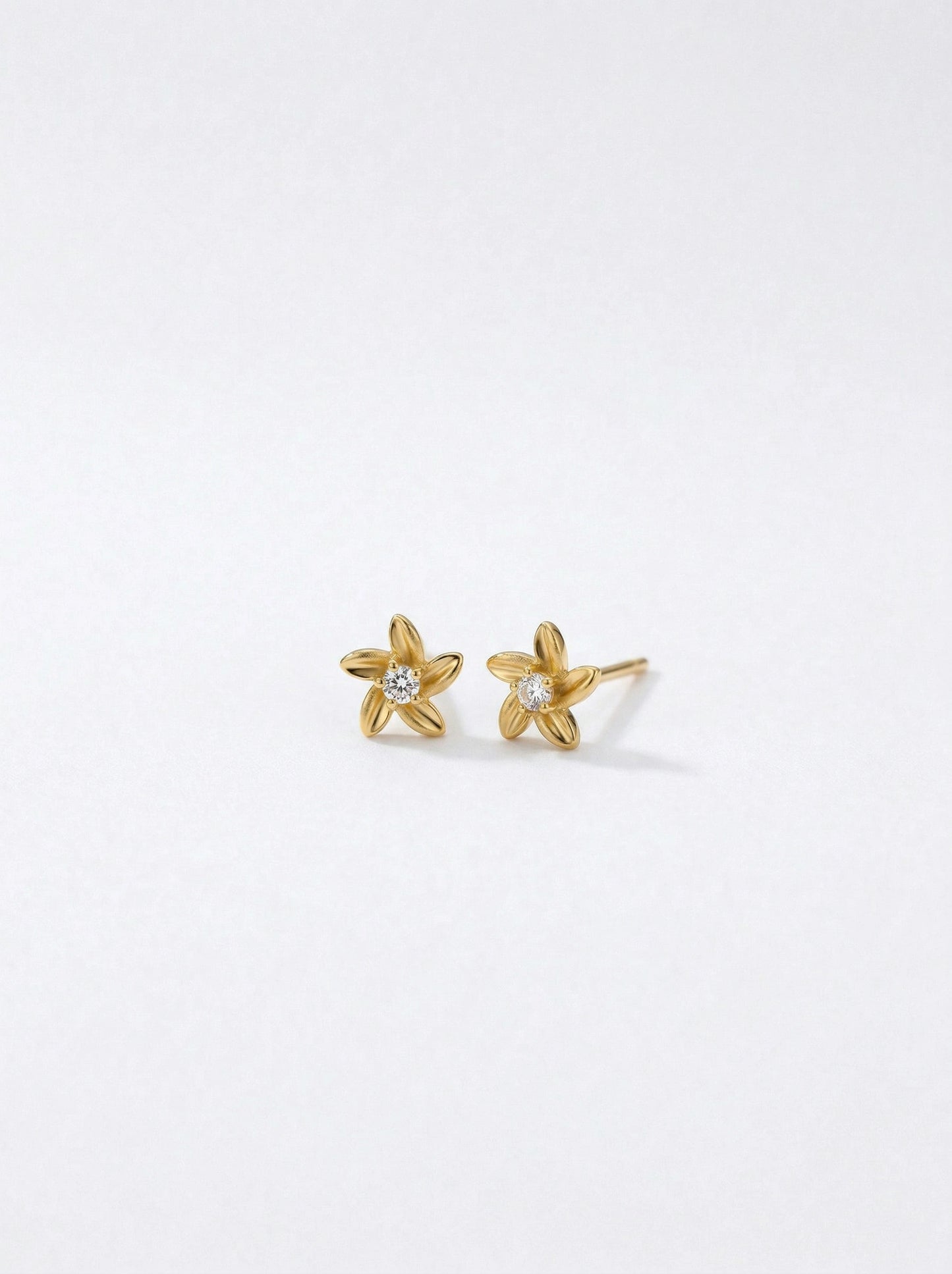18k gold plated star-shaped earrings on a white background