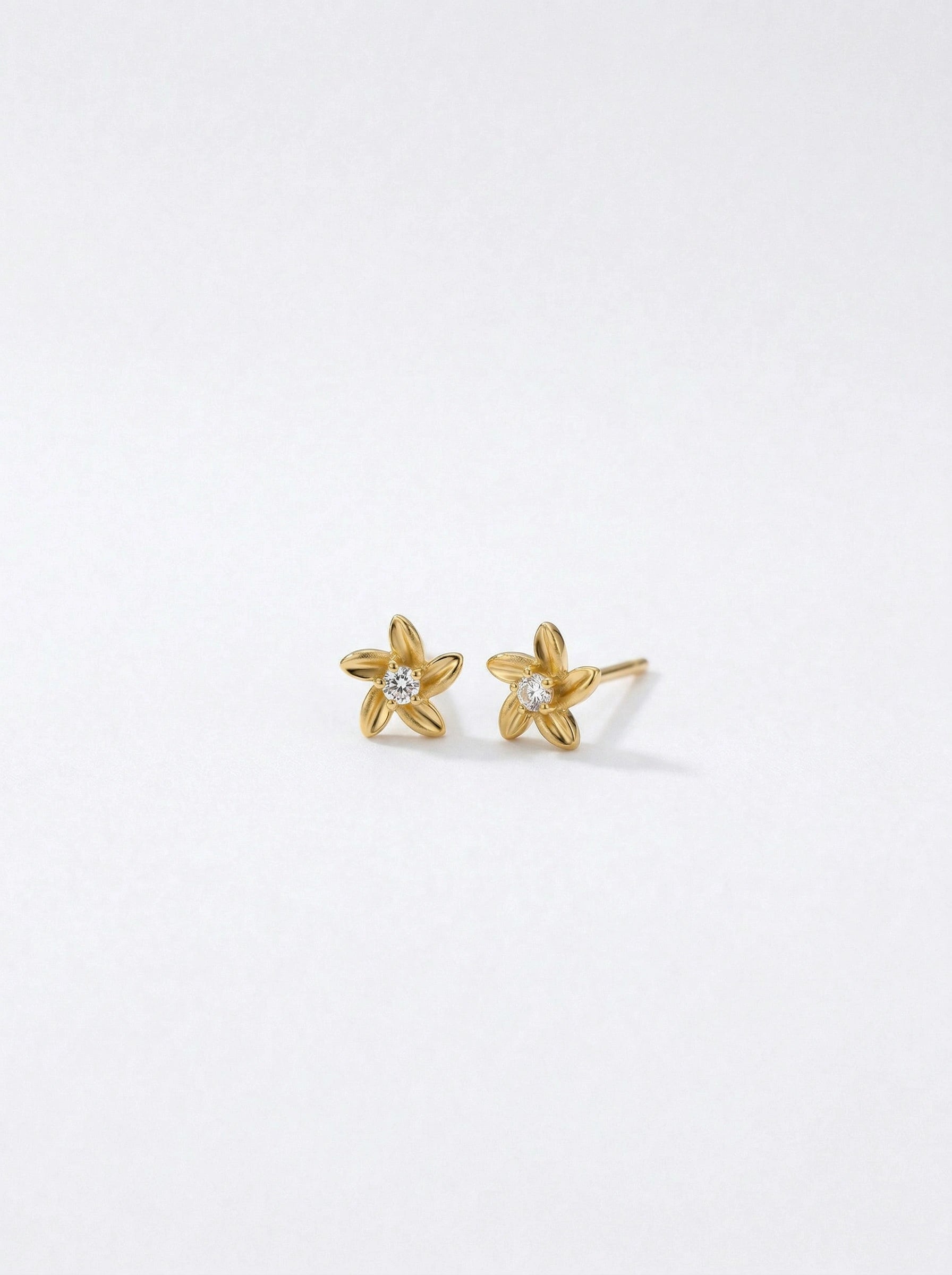 18k Gold plated star-shaped earrings on a white background