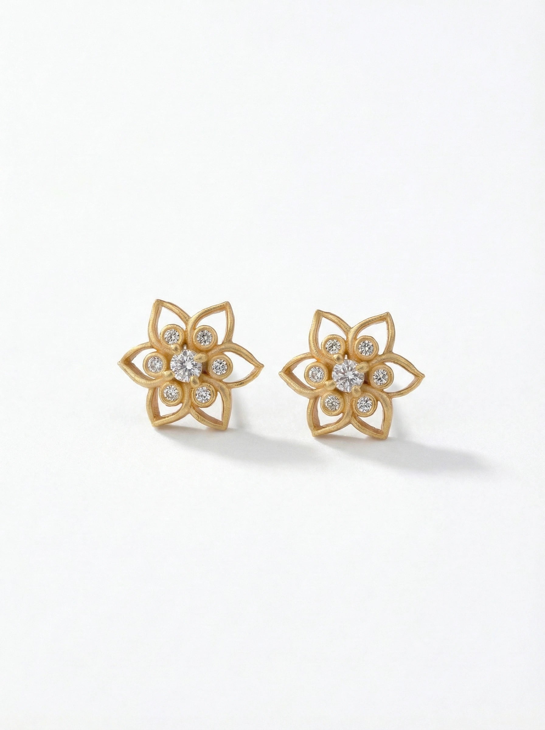 18k Gold plated  flower-shaped earrings with clear stones on a white background