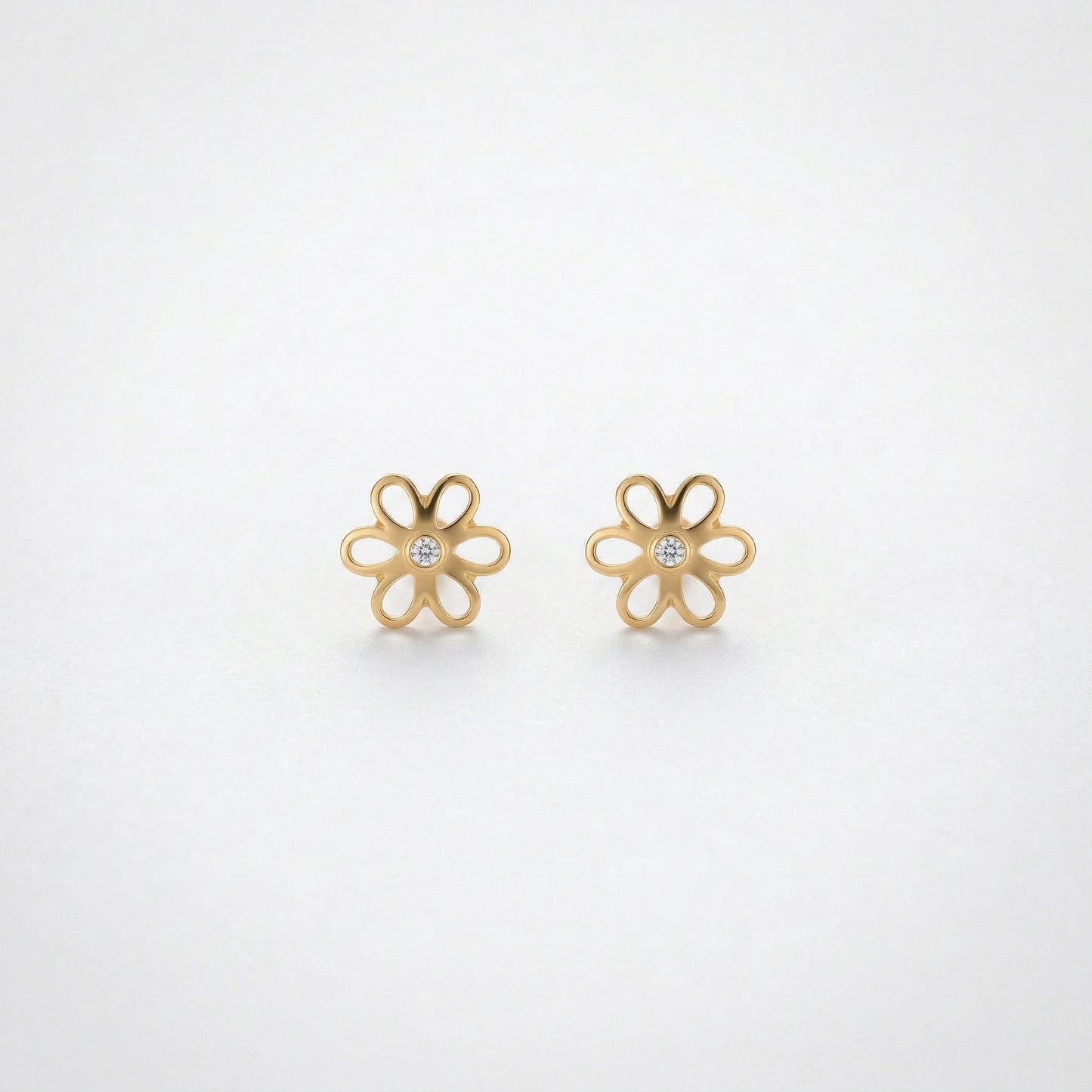 18k gold plated flower-shaped earrings on a light gray background